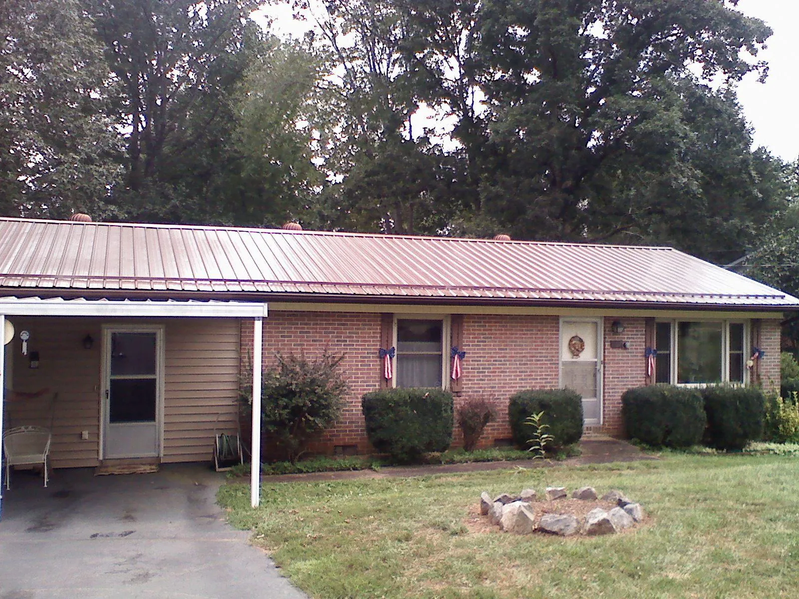 Bronze metal roof and carport on a brick ranch home — Roof Repair work by our crew in Kahlotus