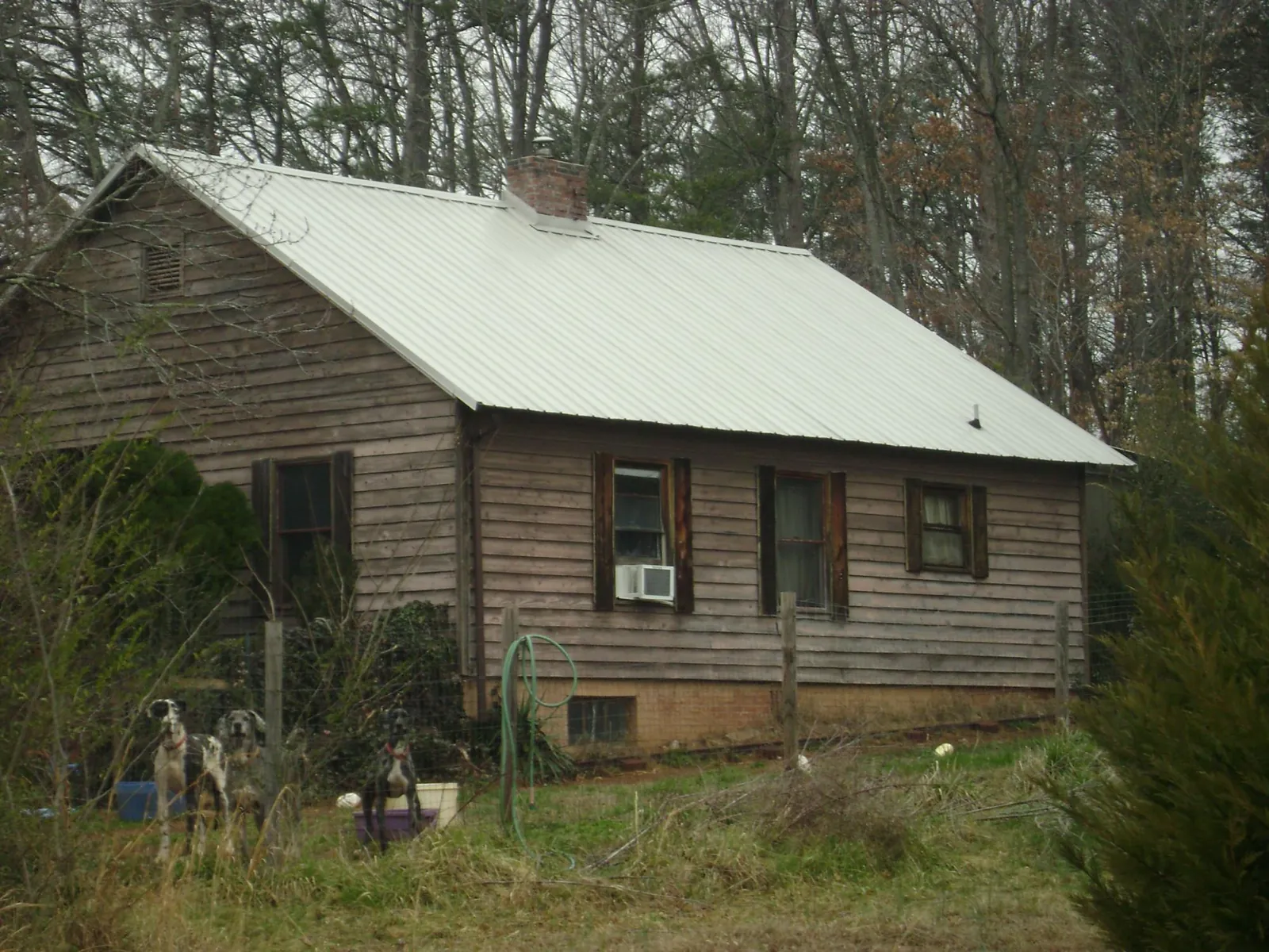 White metal roof on an old wood sided farmhouse, from a Metal Roof Installation job in Kahlotus